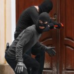 depositphotos_122698402-stock-photo-armed-thieves-breaking-a-door.jpg