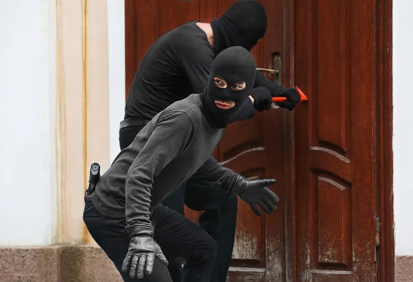 depositphotos_122698402-stock-photo-armed-thieves-breaking-a-door.jpg